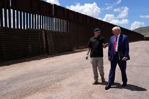 Republican presidential nominee former President Donald Trump listens to Paul Perez, president of the National Border Patrol Council, as he tours the southern border with Mexico, on Aug. 22, 2024, in Sierra Vista, Ariz. (AP Photo/Evan Vucci)