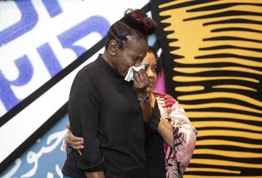 Wanda Cooper-Jones, the mother of Ahmaud Arbery, sobs as she approaches a podium at the Center for Civil and Human Rights on Wednesday, Feb. 23, 2022, in Atlanta. February 23 was declared Ahmaud Arbery Day in Georgia, in honor of the Black man who was shot and killed in 2020 in Brunswick, Ga. (AP Photo/Ron Harris)