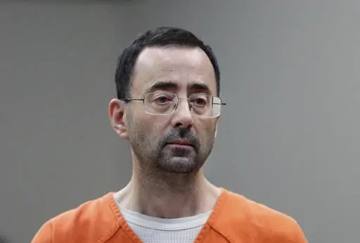 Disgraced former sports doctor Larry Nassar appears in court for a plea hearing, Nov. 22, 2017, in Lansing, Mich. Nassar was stabbed Sunday, July 9, 2023, in his cell at a federal penitentiary in Florida, out of view of surveillance cameras pointed at common areas and corridors. It’s the second time the ex-U.S. women’s gymnastics team doctor has been assaulted in federal custody while serving decades in prison for sexually abusing athletes. (AP Photo/Paul Sancya, File)