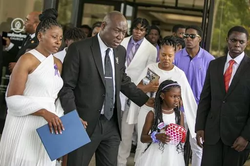 Pamela Dias, the mother of Ajike Owens, left, attorney Ben Crump and Africa Owens leave after the funeral for Owens on Monday, June 12, 2023, at Meadowbrook Church in Ocala, Fla. Owens was fatally shot by her neighbor Susan Lorincz when she went to Lorincz's door. Lorincz was arrested and charged in the shooting. (AP Photo/ Alan Youngblood)