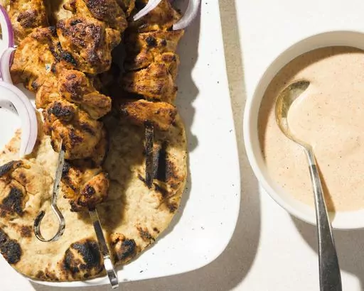 This image released by Milk Street shows a recipe for tandoori-inspired chicken kebabs. (Milk Street via AP)