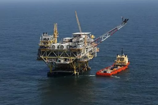A rig and supply vessel are pictured in the Gulf of Mexico, off the cost of Louisiana, April 10, 2011. An auction of federal Gulf of Mexico leases for oil and gas drilling must be held in 37 days, a federal appeals court ruled Tuesday, Nov. 14, 2023, rejecting environmentalists arguments against the sale, and throwing out plans by the Biden administration to scale back the sale to protect an endangered species of whale. (AP Photo/Gerald Herbert, File)