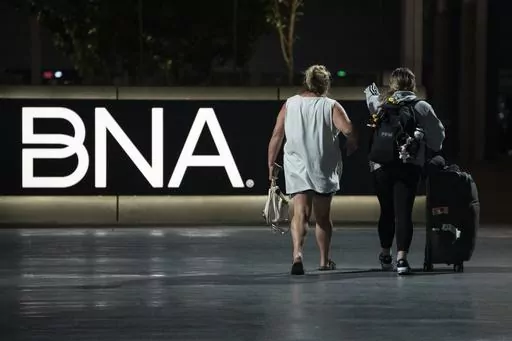 Air travelers make their way through the Nashville International Airport Tuesday, July 25, 2023 in Nashville, Tenn. A new Tennessee law that installs a state takeover of the board that oversees Nashville's airport has created confusion about who is actually running the facility. (AP Photo/George Walker IV)