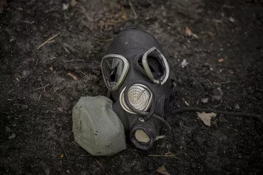 A damaged gas mask lies on the pavement at a Russian position which was overran by Ukrainian forces, outside Kyiv, Ukraine, March 31, 2022. Russia’s assault on Ukraine and its veiled threats of using nuclear arms have policymakers questioning how the West should respond to a Russian battlefield explosion of a nuclear bomb. The default U.S. policy answer, say some architects of the post-Cold War nuclear order, is with discipline and restraint. (AP Photo/Vadim Ghirda, File)