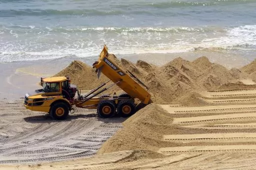 A load of sand is dumped on the beach in front of the Ocean Casino Resort in Atlantic City, N.J., Friday, May 12, 2023. The Ocean, Resorts and Hard Rock casinos want federal officials to expedite a beach replenishment project planned for 2024 so that it creates usable beaches this summer, but the U.S. Army Corps of Engineers says work might not start until the fall. (AP Photo/Wayne Parry, File)