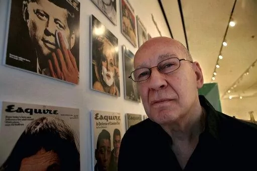 Artist George Lois poses next to his artwork at the New York Museum of Modern Art (MoMA) in New York, April 22, 2008. Lois, the hard-selling, charismatic advertising man and designer who fashioned some of the most daring magazine images of the 1960s and popularized such catchphrases and brand names as “I Want My MTV” and “Lean Cuisine,” has died at age 91. Lois' son, photographer Luke Lois, said he died “peacefully” Friday, Nov. 18, 2022, at his home in Manhattan. (AP Photo/Bebeto Ma