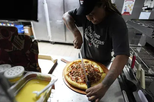 TiAnna Yeldell, a 44-year-old single mom of three, works in the kitchen at Pizza Hut, Thursday, Nov. 14, 2024, in Missouri City, Texas. (AP Photo/Eric Gay)
