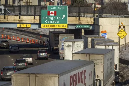 A small line of semi-trailer trucks line up along northbound I-75 in Detroit as the Ambassador Bridge entrance is blocked off for travel to Canada on Tuesday, Feb. 8, 2022. Canadian lawmakers are expressing increasing worry about the economic effects of disruptive COVID-19 demonstrations. They spoke Tuesday after the busiest border crossing between the U.S. and Canada became partially blocked by truckers protesting vaccine mandates and other coronavirus restrictions. The Ambassador Bridge betwee