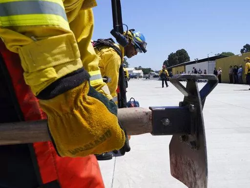 Cadets, who were formerly-incarcerated firefighters, train at the Ventura Training Center (VTC) during an open house media demonstration Thursday, July 14, 2022, in Camarillo, Calif. California has a first-in-the nation law and a $30 million training program both aimed at trying to help former inmate firefighters turn pro after they are released from prison. The 18-month program is run by Cal Fire, the California Conservation Corps, the state corrections department and the nonprofit Anti-Recidiv