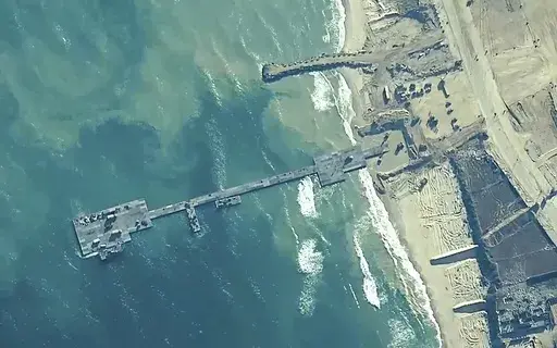 The image provided by U.S, Central Command, shows U.S. Army soldiers assigned to the 7th Transportation Brigade (Expeditionary), U.S. Navy sailors assigned to Amphibious Construction Battalion 1, and Israel Defense Forces placing the Trident Pier on the coast of Gaza Strip on May 16, 2024. A key section of the U.S. military-built pier designed to carry badly needed aid into Gaza by boat has been reconnected to the Gaza beach following storm damage repairs and aid will begin to flow soon, the U.S