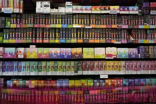 Disposable flavored electronic cigarette devices are displayed for sale at a store in Pinecrest, Fla., Monday, June 26, 2023. (AP Photo/Rebecca Blackwell, File)