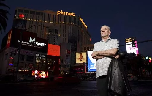 Jeff German, host of "Mobbed Up," poses with Planet Hollywood, formerly the Aladdin, in the background on the Strip in Las Vegas, Wednesday, June 2, 2021. Authorities say German, a Las Vegas investigative reporter has been stabbed to death outside his home and police are searching for a suspect. The Las Vegas Review-Journal says officers found journalist German dead with stab wounds around 10:30 a.m. Saturday, Sept. 3, 2022, after authorities received a 911 call. (K.M. Cannon/Las Vegas Review-Jo