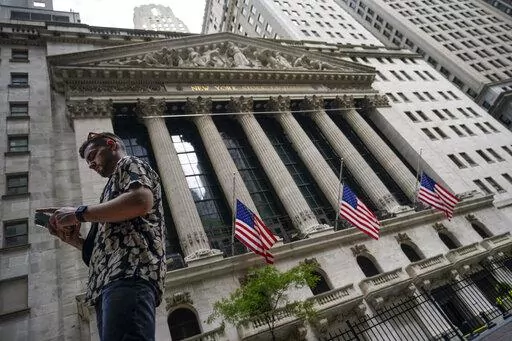 Pedestrians walk past the New York Stock Exchange, on July 8, 2022, in New York.  Stocks rose on Wall Street, Friday, Sept. 9, keeping the market on a track to break a three-week losing streak.  (AP Photo/John Minchillo, file)