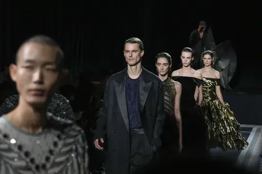 Models wear creations for the men's and women's Lanvin Fall-Winter 2025-2026 collection, presented in Paris, Sunday, Jan. 26, 2025. (AP Photo/Michel Euler)