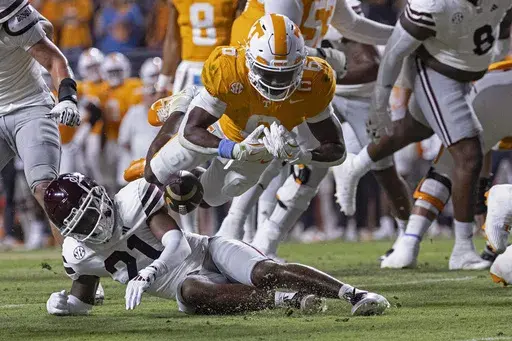 Tennessee running back Dylan Sampson (6) fumbles the ball as he's hit by Mississippi State safety Hunter Washington (21) during the first half of an NCAA college football game Saturday, Nov. 9, 2024, in Knoxville, Tenn. (AP Photo/Wade Payne)