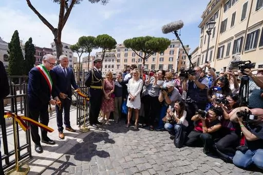 Rome's Mayor Roberto Gualtieri, left, and Bulgari CEO Jean-Christophe Babin cut the ribbon to inaugurate the walkways and nighttime illumination of the so called 'Sacred Area' where four temples, dating back as far as the 3rd century B.C., stand smack in the middle of one of modern Rome's busiest crossroads, Monday, June 19, 2023, With the help of funding from Bulgari, the luxury jeweler, the grouping of temples can now be visited by the public that for decades had to gaze down from the bustling