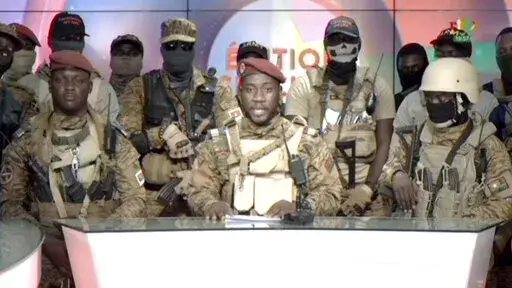 In this image from video broadcast by RTB state television, coup spokesman Capt. Kiswendsida Farouk Azaria Sorgho reads a statement in a studio in Ougadougou, Burkina Faso, on Friday evening, Sept. 30, 2022. Members of Burkina Faso's army seized control of state television late Friday, declaring that the country's coup leader-turned-president, Lt. Col. Paul Henri Sandaogo Damiba, had been overthrown after only nine months in power. The statement announced that Capt. Ibrahim Traore is the new mil