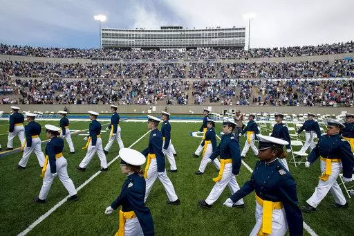 Air Force Academy cadets make their way to their seats as family and friends cheer from the stands during the United States Air Force Academy's Class of 2021 graduation ceremony at the USAFA in Colorado Springs, Colo., on May 26, 2021. Four cadets at the Air Force Academy may not graduate or be commissioned as military officers in May 2022, because they have refused the COVID-19 vaccine, and they may be required to pay back thousands of dollars in tuition costs, according to Air Force officials.
