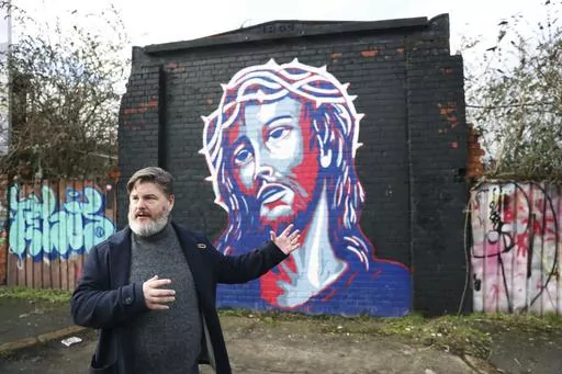 Jonny Clark, program manager for public theology at Corrmeela, an organisation that has worked for decades toward reconciliation in Northern Ireland, visits the peace walls in west Belfast, Northern Ireland, Saturday, Jan. 28, 2023. Twenty-five years ago, the Good Friday Agreement halted much of the violence of Northern Ireland’s Troubles. Today, grassroots faith leaders are trying to build on that opportunity. They're working toward reconciliation in a land where religion was often part of th