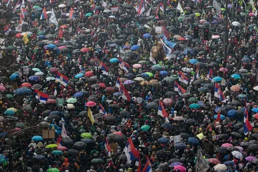 People gather in front of the Serbian parliament during a major anti-corruption rally led by university students in Belgrade, Serbia, Saturday, March 15, 2025. (AP Photo/Marko Drobnjakovic)