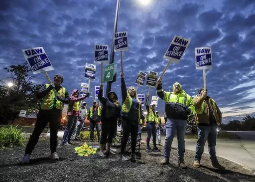 UAW local 862 members strike outside of Ford's Kentucky Truck Plant in Louisville, Ky. on Thursday, Oct. 12, 2023. The United Auto Workers union significantly escalated its walkout against Detroit's Three automakers, shutting down Ford's largest factory and threatening Jeep maker Stellantis. (Michael Clevenger/Courier Journal via AP)