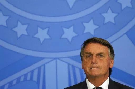 Brazil's President Jair Bolsonaro attends a meeting with parliamentarians at the Planalto Presidential Palace, in Brasilia, Brazil, Wednesday, April 27, 2022. (AP Photo/Eraldo Peres)