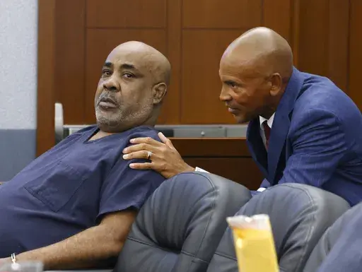 Duane "Keffe D" Davis, left, who is accused of orchestrating the 1996 slaying of hip-hop icon Tupac Shakur, listens to his attorney Carl Arnold during a hearing to reconsider his bond at the Regional Justice Center, on Tuesday, July. 23, 2024, in Las Vegas. (Bizuayehu Tesfaye/Las Vegas Review-Journal via AP)