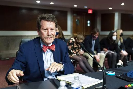 Dr. Robert Califf gathers his documents as the Senate Committee on Health, Education, Labor and Pension adjourn a hearing on the nomination of Califf to be Commissioner of Food and Drug Administration on Capitol Hill in Washington, on Dec. 14, 2021. (AP Photo/Manuel Balce Ceneta, File)