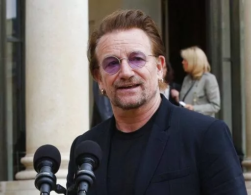U2 singer Bono speaks to the media after a meeting at the Elysee Palace, in Paris, France on July 24, 2017.  Bono's memoir "Surrender" planned for release on Nov. 1. (AP Photo/Michel Euler, File)