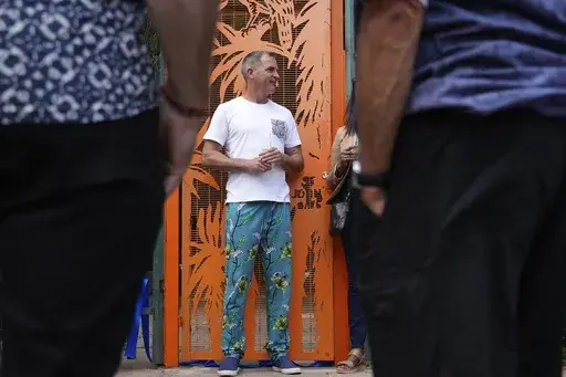 South African sculptor and painter James Delaney speaks to the residents during his official opening his public art installation, at the Killarney Park in Johannesburg, South Africa, Tuesday Feb. 18, 2025. (AP Photo/Alfonso Nqunjana)
