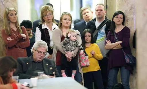 Parents with their children and medical professionals listen to testimony from proponents for allowing exemption from the vaccination requirement for school attendance based on religious beliefs during a meeting of House Judiciary B Committee, Jan. 24, 2018, at the Capitol in Jackson, Miss. A federal judge ruled Monday, April 17, 2023, that Mississippi must join most other states in allowing religious exemptions from vaccinations required before children can enroll in school. (AP Photo/Rogelio V