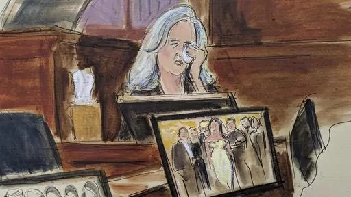In this courtroom sketch, Natasha Stoynoff weeps on while testifying that Donald Trump pushed himself on to her and made a sexual advance at Mar-a-Lago during her assignment interviewing him and his wife Melania on their one year anniversary, during writer E. Jean Carroll's lawsuit against former President Trump, Wednesday, May 3, 2023, in Manhattan federal court in New York. A photograph of the magazine crew, including Stoynoff, with Donald Trump and Melania is displayed on a computer monitor. 