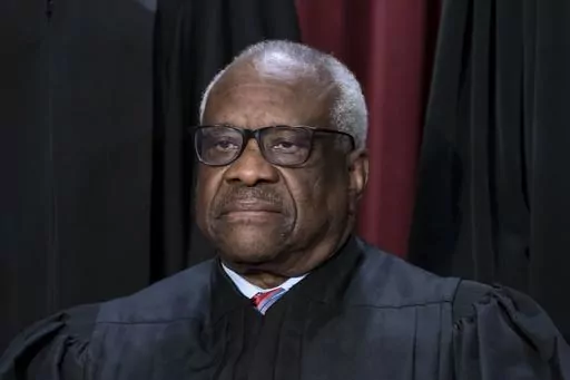 Associate Justice Clarence Thomas joins other members of the Supreme Court as they pose for a new group portrait, at the Supreme Court building in Washington, Oct. 7, 2022. Conservative mega-donor Harlan Crow purchased three properties belonging to Thomas and his family, in a transaction worth more than $100,000 that Thomas never reported, according to the non-profit investigative journalism organization ProPublica on Thursday, April 13, 2023. (AP Photo/J. Scott Applewhite, File)