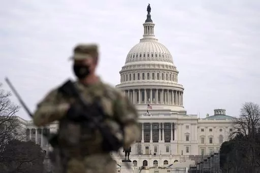 A member of the National Guard patrols the area outside of the U.S. Capitol at the Capitol in Washington, Wednesday, Feb. 10, 2021. The House passed a defense policy bill Thursday, Dec. 14, 2023, that authorizes the biggest pay raise for troops in more than two decades, overcoming objections from some conservatives concerned the measure did not do enough to restrict the Pentagon's diversity initiatives, abortion travel policy and gender-affirming health care for transgender service members. (AP 