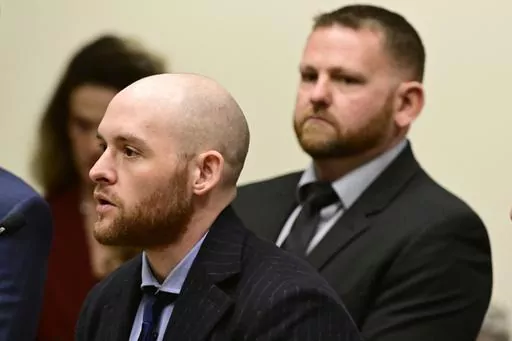 Former Officer Jason Rosenblatt, left, and Aurora Police Officer Randy Roedema, right, attend an arraignment at the Adams County Justice Center in Brighton, Colo., Jan. 20, 2023. The two officers face felony charges in the 2019 death of Elijah McClain. (Andy Cross/The Denver Post via AP, File)