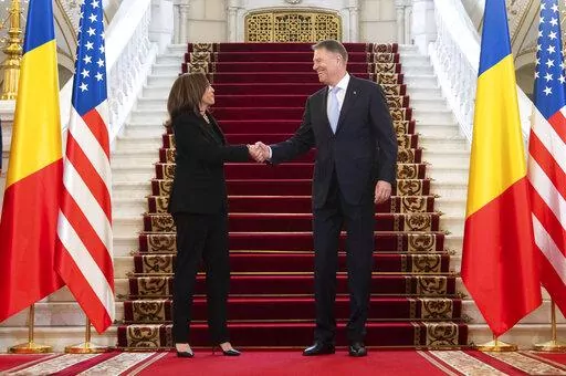 Romanian President Klaus Iohannis shakes hands with US Vice President Kamala Harris as she arrives for a meeting at Cotroceni Palace in Otopeni, Romania, Friday, March 11, 2022. (Saul Loeb/Pool Photo via AP)