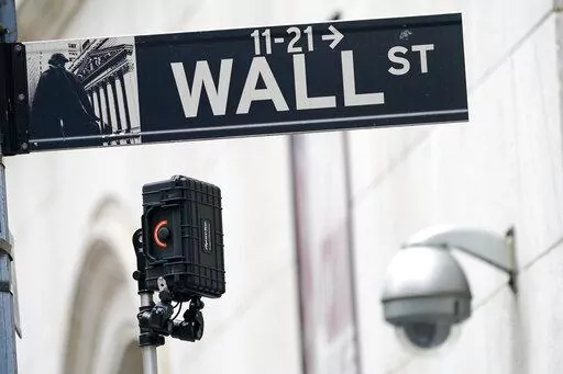 A Wall Street sign is seen next to surveillance equipment outside the New York Stock Exchange, Oct. 5, 2021, in New York.  Stocks are opening lower on Wall Street Friday, Jan. 14, 2022 keeping the S&P 500 on course for its second weekly decline in a row. (AP Photo/Mary Altaffer, file)