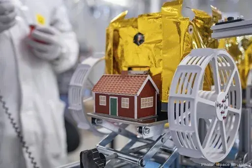 This photo provide by The Moonhouse project and taken in September 2024 at the ispace facilities in Japan, shows a little red model house created by artist Mikael Genberg and scheduled to launched into space on a Falcon 9 rocket from Cape Canaveral in Florida on Wednesday, Jan. 15, 2025. (ispace mission 2 via AP)