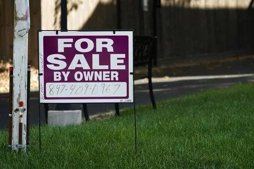 For sale by owner sign is displayed outside home in Northbrook, Ill., Wednesday, Sept. 21, 2022. Average long-term U.S. mortgage rates rose this week for the sixth straight week, marking new highs not seen in 15 years, before a crash in the housing market triggered the Great Recession, mortgage buyer Freddie Mac reported Thursday, Sept. 29, 2022. (AP Photo/Nam Y. Huh)