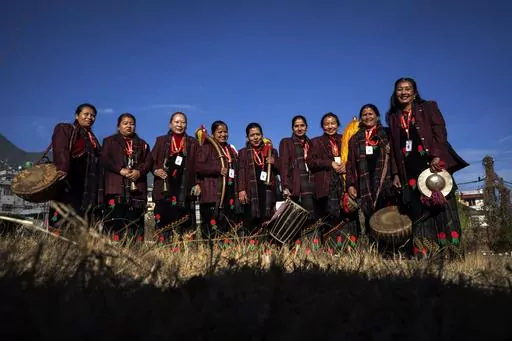 Band members of Shrijanshil Mahila Sanstha, or the Self-Reliant Women’s Group, stand for a photograph before they prepare to play at a wedding in Kathmandu, Nepal, Wednesday, March 6, 2024. Once associated only with men from the Damai community, part of the lowest caste, these nine women have come together to play the naumati baja, or nine traditional instruments. Discrimination based on caste is believed to have caused some Dalit musicians to quit playing naumati baja. (AP Photo/Niranjan Shre