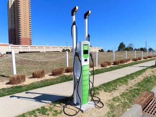 An electric vehicle charging station is pictured on March 21, 2022, in Asbury Park, N.J. Communities across the U.S. are adding such stations in an effort that began well before gasoline prices surged this year. (AP Photo/Wayne Parry)