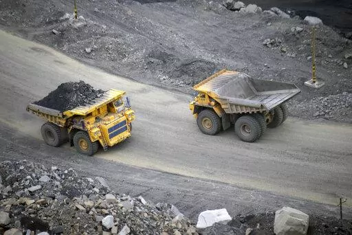 A loaded dump truck passes an empty truck as it carries away coal at the Kedrovsky open-pit coal mine in Kemerovo, Russia, Tuesday, June 16, 2015. Poland’s government has decided to block imports of coal from Russia. The move is an element in a larger strategy to reduce energy dependence on Russia which gained new urgency after the invasion of Ukraine. The government of Prime Minister Mateusz Morawiecki agreed to impose financial penalties on the private entities importing Russian coal into Po