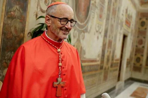 Cardinal Michael Czerny poses for photographers prior to meeting relatives and friends after he was elevated to cardinal by Pope Francis, at the Vatican, Oct. 5, 2019. Cardinal Michael Czerny marked the 80th anniversary of the gas chamber killing of the Jewish-born Catholic convert Edith Stein on Tuesday Aug. 9, 2022, by celebrating a Mass at the former Auschwitz death camp and telling the story of his own family’s Jewish origins and their fate with the Nazis. (AP Photo/Andrew Medichini, File)