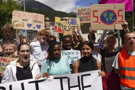 Climate activists Elizabeth Wathuti of Kenia, Vanessa Nakate of Uganda and Helena Gualinga of Ecuador attend the climate protest alongside the World Economic Forum in Davos, Switzerland, Thursday, May 26, 2022. The annual meeting of the World Economic Forum is taking place in Davos from May 22 until May 26, 2022. (AP Photo/Evgeniy Maloletka)