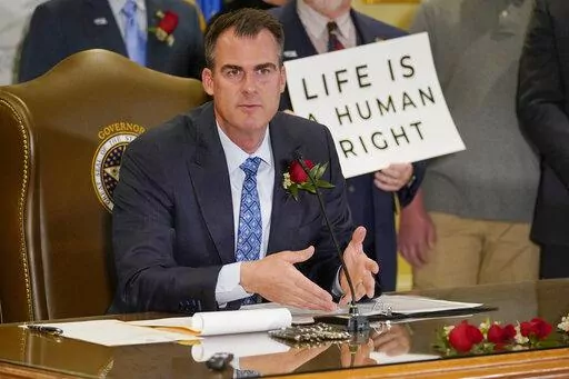 Oklahoma Gov. Kevin Stitt speaks after signing into law a bill making it a felony to perform an abortion, punishable by up to 10 years in prison, Tuesday, April 12, 2022, in Oklahoma City. (AP Photo/Sue Ogrocki)