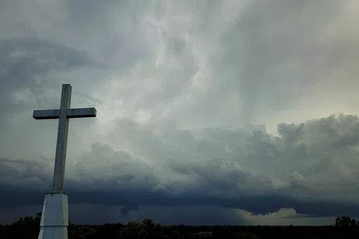 Storm clouds approach a church in Mequon, Wis., on Sunday, Aug. 2, 2020. A new Pew Research Center report published Thursday, Nov. 17, 2022 explores how religion in the U.S. intersects with views on the environment and climate change. (AP Photo/Morry Gash)