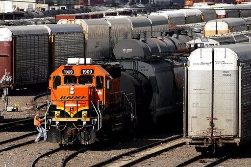 A worker boards a locomotive at a BNSF rail yard Wednesday, Sept. 14, 2022, in Kansas City, Kan. Business and government officials are preparing for a potential nationwide rail strike at the end of this week while talks carry on between the largest U.S. freight railroads and their unions. (AP Photo/Charlie Riedel)
