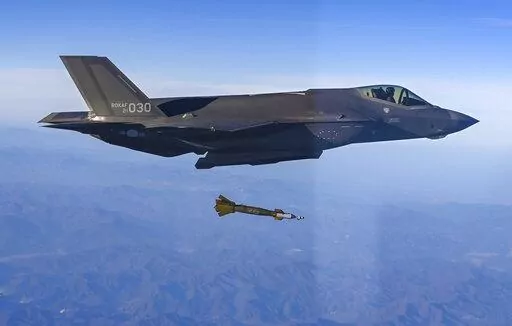 In this photo provided by South Korean Defense Ministry, South Korean Air Force F-35 fighter jet fires a GBU-12 aerial laser-guided bomb at a firing range near its land border with North Korea, South Korea, Friday, Nov. 18, 2022. South Korea's military said Friday its F-35 fighter jets conducted drills simulating aerial strikes on North Korean mobile missile launchers at a firing range near its land border with North Korea. It said a group of eight South Korean and U.S. fighter jets separately p