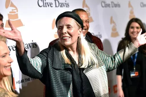 Joni Mitchell arrives at the 2015 Clive Davis Pre-Grammy Gala in Beverly Hills, Calif. Feb. 7, 2015. Joni Mitchell said Friday, Jan. 28, 2022 she seeks to remove all of her music in Spotify in solidarity with Neil Young, who ignited a protest against the streaming service for airing a podcast that featured a figure who has spread misinformation about the coronavirus. (Photo by John Shearer/Invision/AP, File)