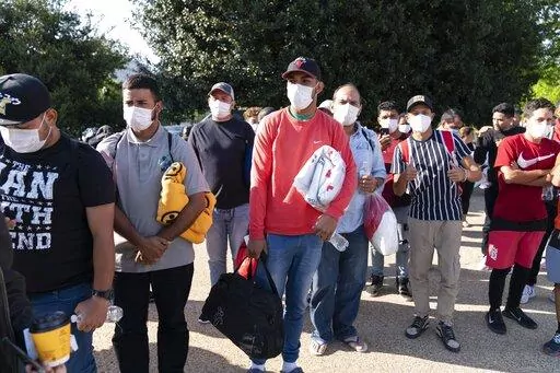 Migrants hold Red Cross blankets after arriving at Union Station near the U.S. Capitol from Texas on buses, April 27, 2022, in Washington. The District of Columbia has requested National Guard assistance to help stem a "growing humanitarian crisis" prompted by thousands of migrants that have been sent to Washington by governors in Texas and Arizona. (AP Photo/Jose Luis Magana, File)